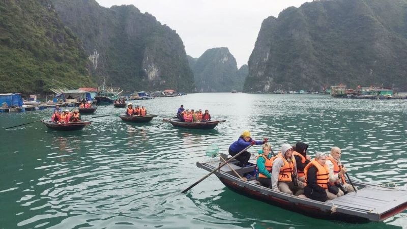 Tourists visiting Cua Van Fishing Village by boat